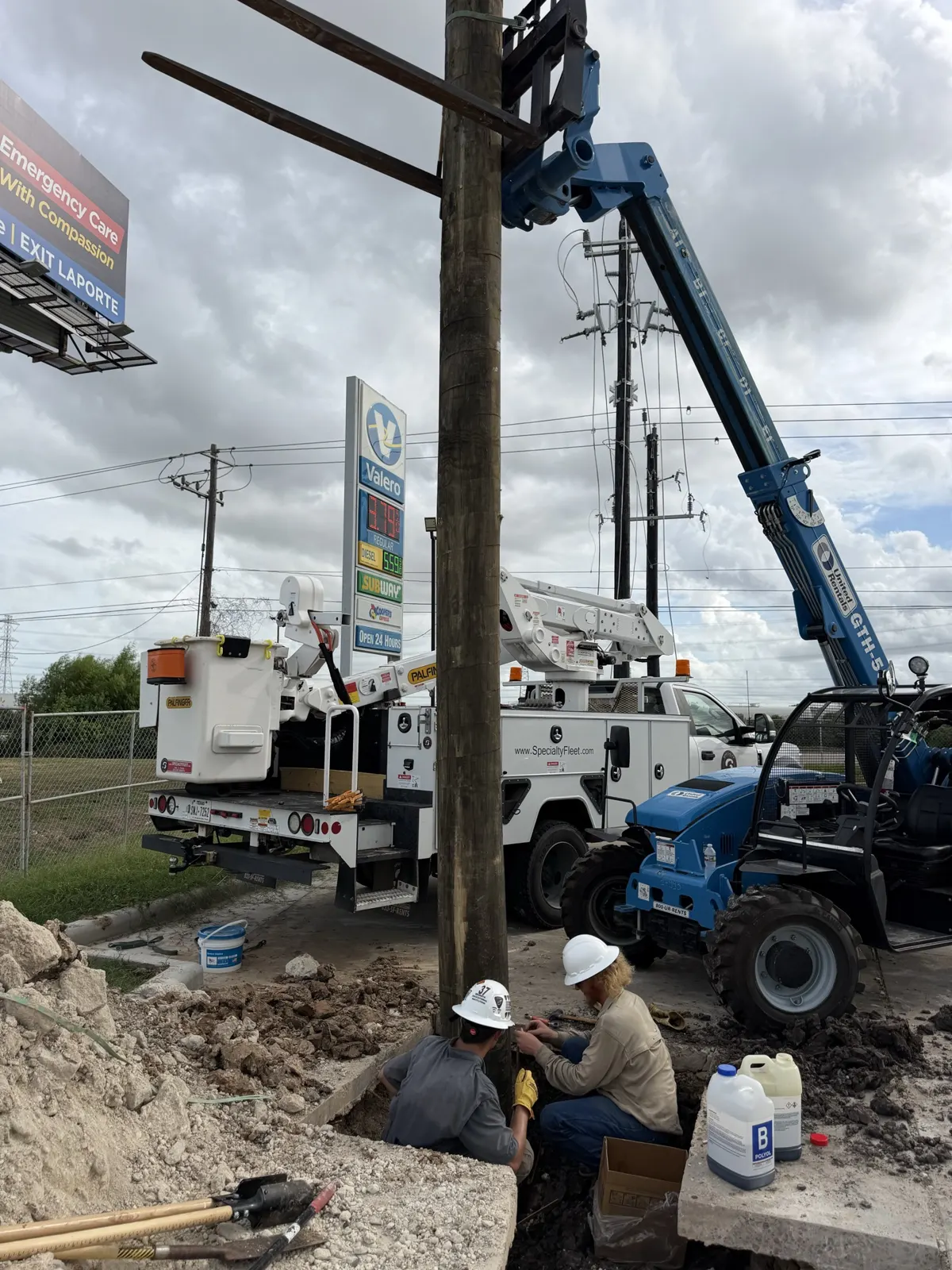Telehandler and bucket truck setting a utility pole in La Porte, TX