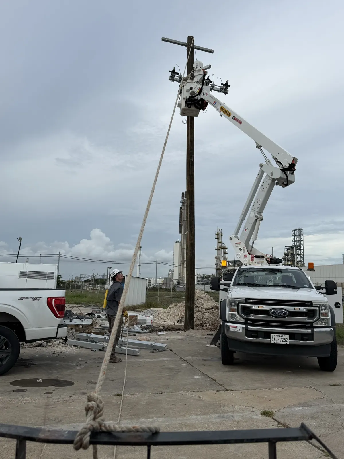 Bucket truck boom raised beside a utility pole in La Porte, TX