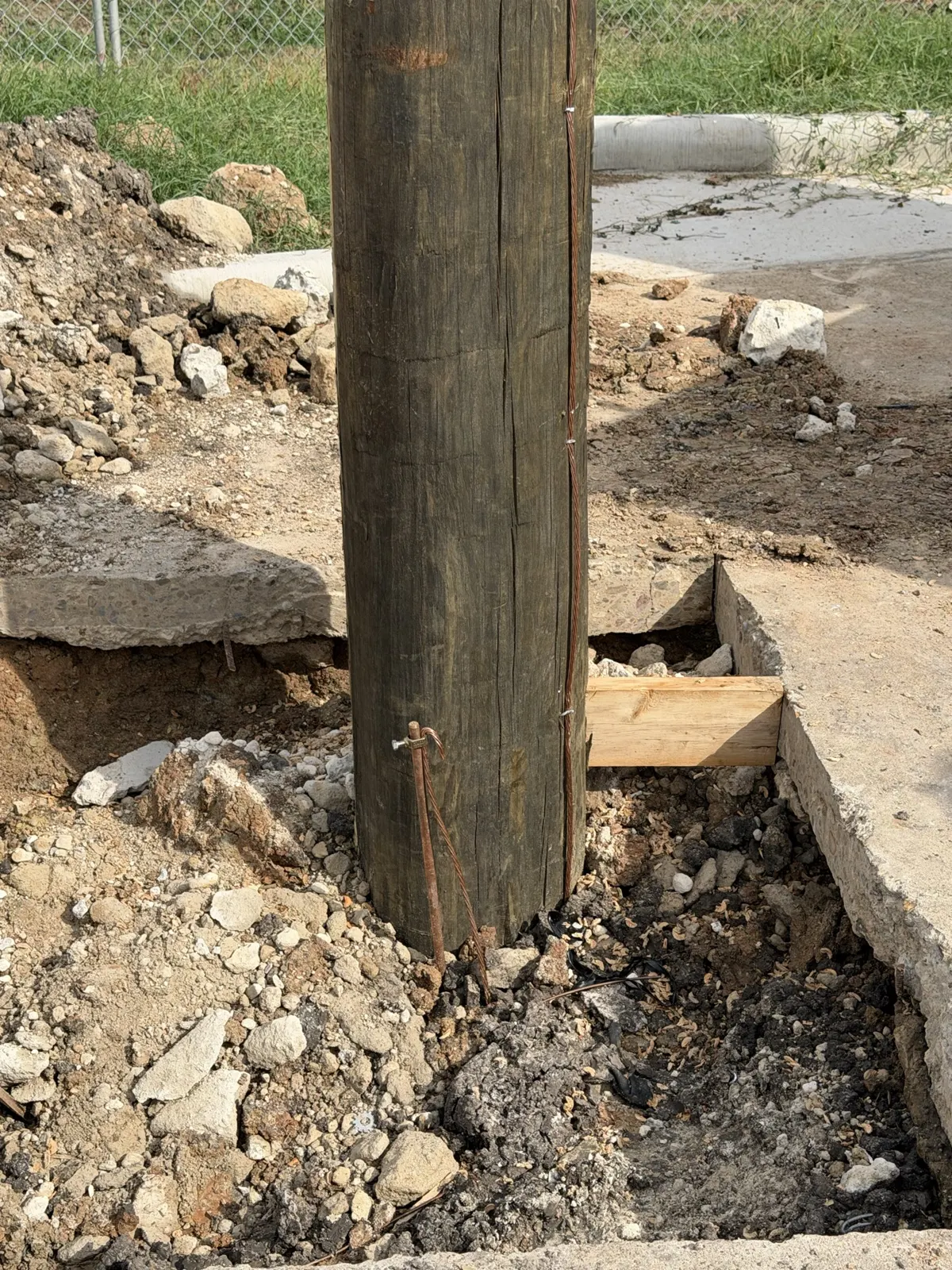 Base of a new utility pole with backfilled soil in La Porte, TX