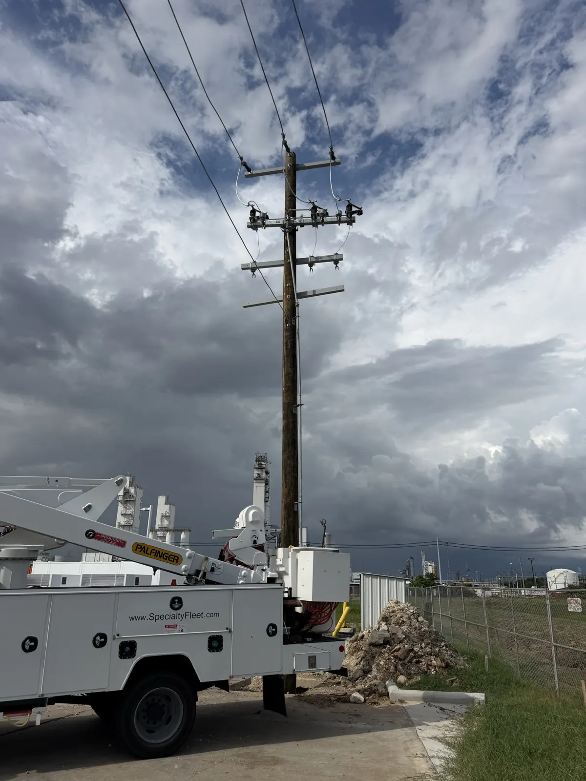 Utility pole with crossarm against a cloudy sky in La Porte, TX