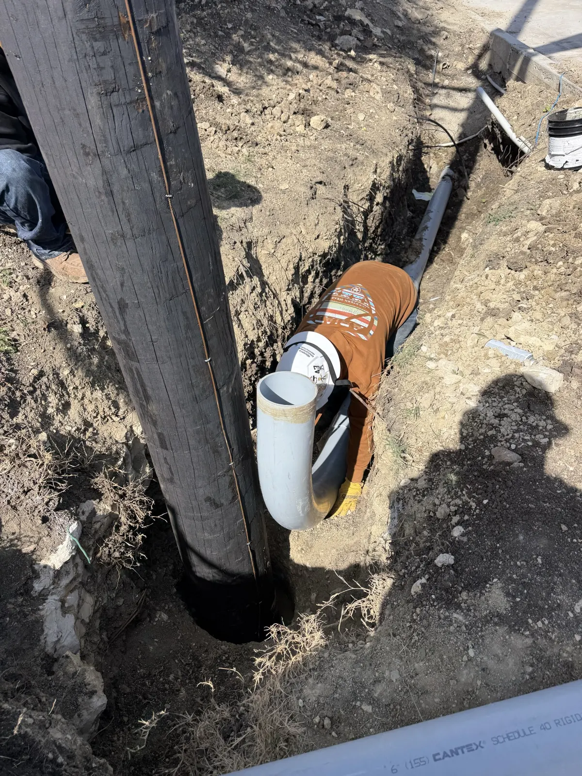 Telehandler holding a utility pole upright during pole setting in Saginaw, TX