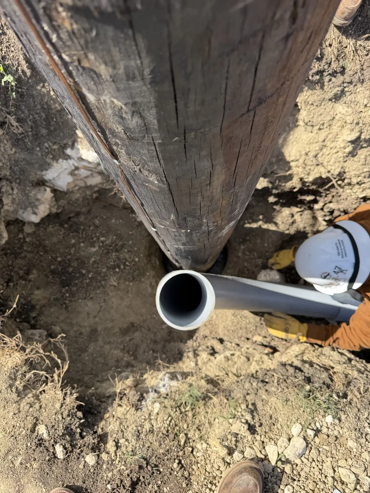 Conduit sweep coming up beside the base of a utility pole in Saginaw, TX