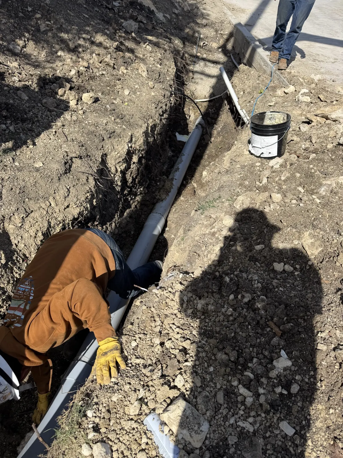 Underground conduit laid in a trench alongside a utility pole in Saginaw, TX
