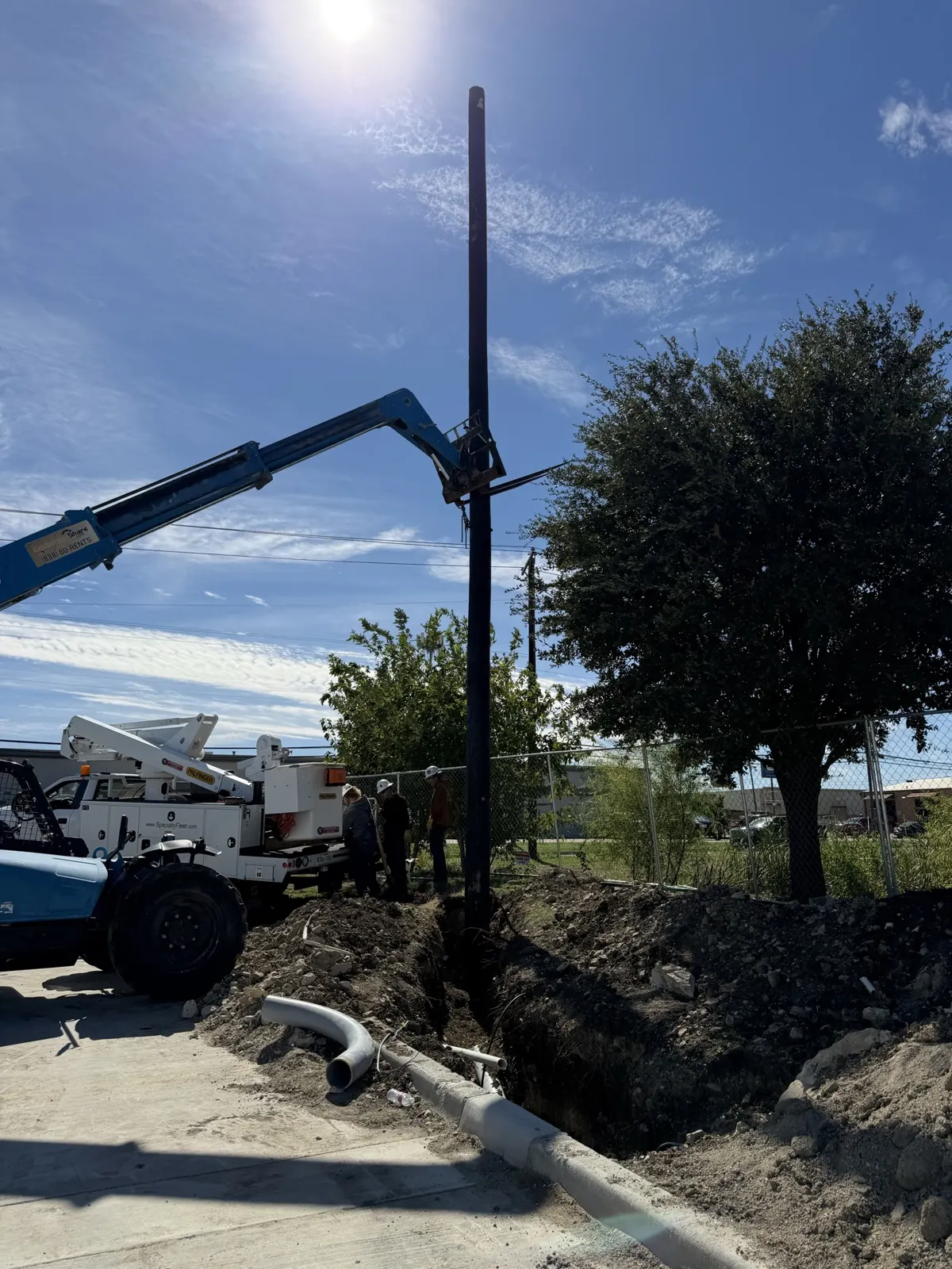 Telehandler and new utility pole beside a trench in Saginaw, TX